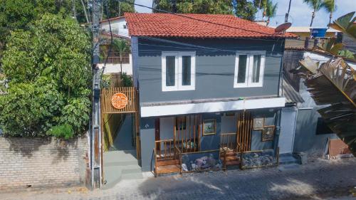 a blue building with a sign in front of it at Pipa Surf House in Pipa