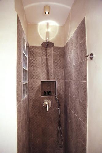 a bathroom with a shower with a shower head at To Nisi in Loutraki