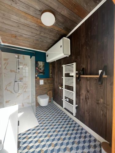 a bathroom with a toilet and a sink and a shower at La Découverte Trouvée in Auxon