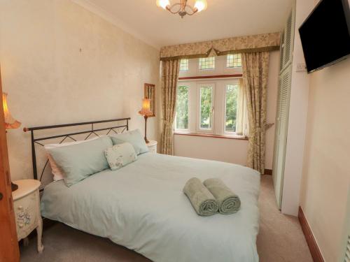 a bedroom with a white bed with towels on it at The Haven in Morecambe