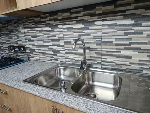 a stainless steel sink in a kitchen at Casa en Sur de Quito in Quito