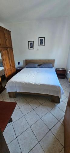 a bedroom with a large bed in a room at Apartments Hugo in Malinska