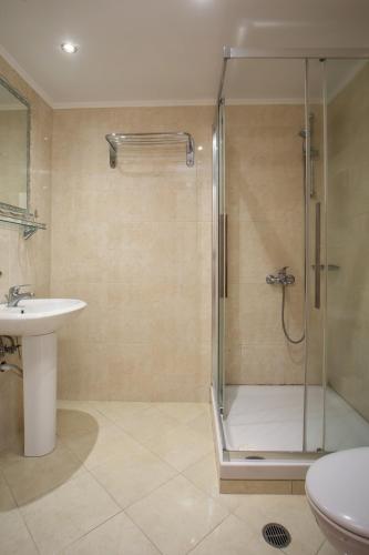 a bathroom with a shower and a sink at Perla Marina Hotel in Ialysos