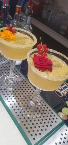 two cocktails sitting on top of a table at Hotel Dante in Cattolica