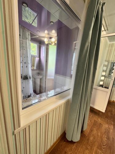 a bathroom with a window and a toilet in it at Гостевой дом Надежда in Zatoka