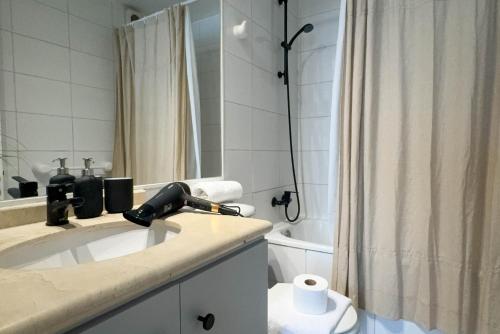 a bathroom with a sink and a shower at Manuel Montt Spot by AndesPlus in Santiago