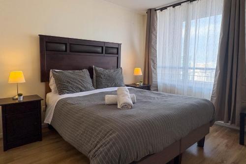 a bedroom with a large bed with two pillows on it at Manuel Montt Spot by AndesPlus in Santiago