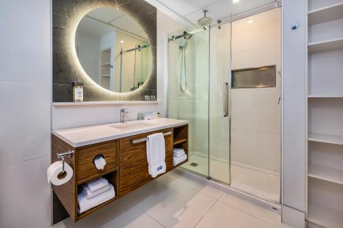 a bathroom with a sink and a shower at Hotel Royal William, an Ascend Collection Hotel in Quebec City