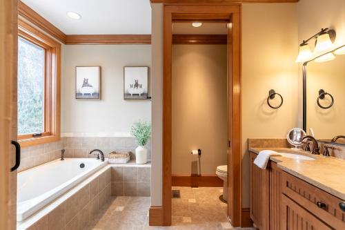 a bathroom with a tub and a sink at Headwaters Hideaway in Elk Park