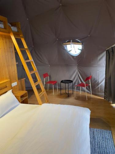a bedroom with two chairs and a table in a tent at Devshal Eco-Stays in Gupta Kāshi