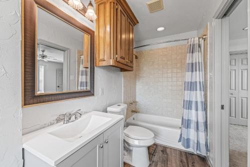 a bathroom with a sink and a toilet and a mirror at Crooked F Ranch in Stephenville