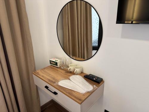 a bathroom with a vanity with a mirror at Gatsby Djal in Bishkek