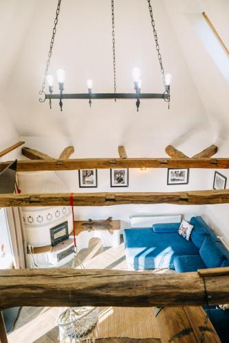 a room with a bed and a chandelier at Demeter Guesthouse WOLF Siklod in Şiclod