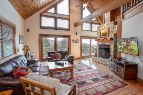 a living room with leather furniture and a fireplace at Resting on the Ridge in Beech Mountain
