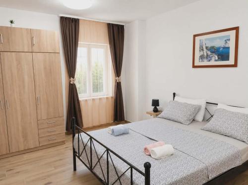 a bedroom with a bed with two towels on it at Apartma PERIN in Dobrovo