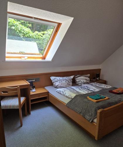 a bedroom with a bed and a window at Biker Hotel Harmonie in Bad Grund