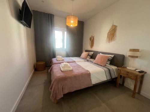 a bedroom with a bed with two towels on it at Tavira Central Harmony in Tavira