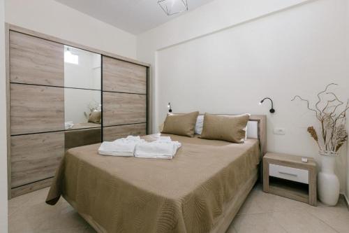 a bedroom with a bed with towels on it at Stella's Apartment in Karfas