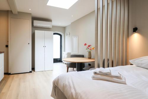 a hotel room with a bed and a table at City Suite Sneek in Sneek