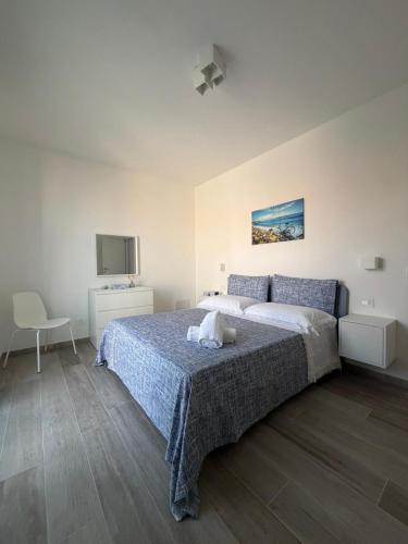 a bedroom with a large bed and a tv at Casa Zia Maria in Pollina