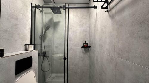 a shower with a glass door in a bathroom at Тихий Замок Джал in Bishkek