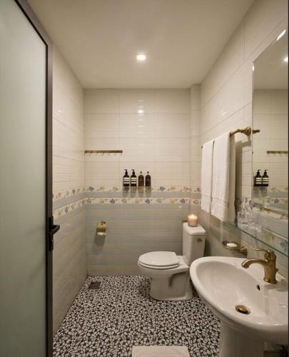 a bathroom with a toilet and a sink at An Phú Nguyễn Hoàng Hotel in Hanoi