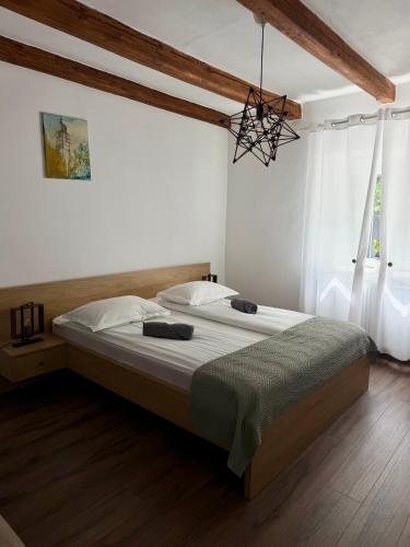 a bedroom with a large bed with a chandelier at Apartament Turnul Olarilor in Sibiu
