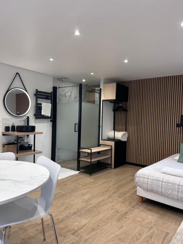 a bedroom with a bed and a table and a table and chairs at Studio chic et cocon proche de Disney in Lagny