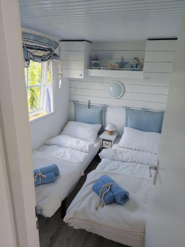 a room with three beds and a window at Biały domek in Zastań