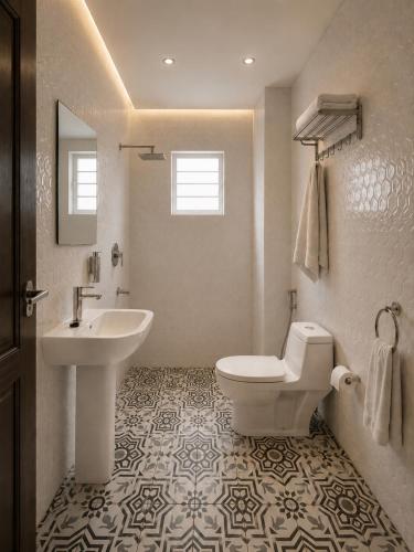 a white bathroom with a sink and a toilet at Cape Town K Hotel in Kigali