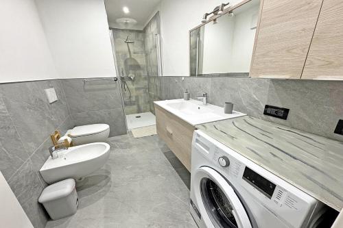 a bathroom with a washing machine and a sink at All'antica Birreria in Predazzo