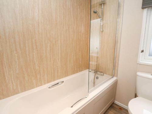 a bathroom with a shower and a tub and a toilet at Rowan in Crieff