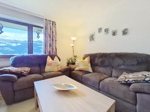 a living room with a couch and a coffee table at Apartment Höllwarth by Interhome in Fügenberg