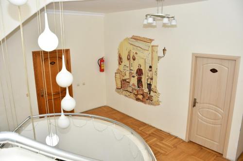 a bathroom with a tub and a painting on the wall at Old Town Hotel in Baku
