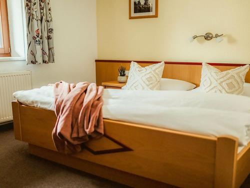a bedroom with a bed and a bath tub at Apartment Kraftreich Apartments-4 by Interhome in Aschau