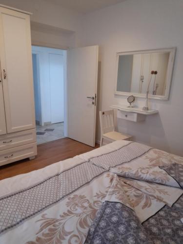 a bedroom with a large bed and a white door at Villa Domic in Slatine