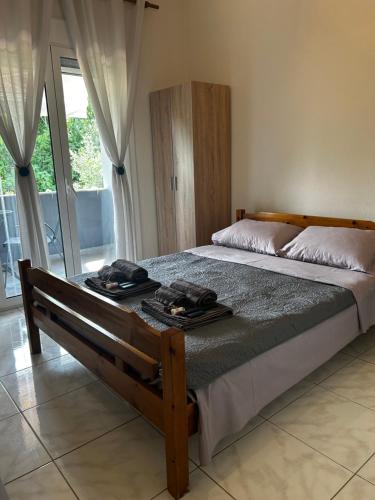 a bedroom with a bed with two towels on it at Anna rooms ANTHOS GROUP in Nea Vrasna