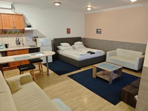 a living room with a couch and a table at Kettő Ciprus Apartman in Hajdúszoboszló