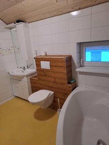 a bathroom with a tub and a toilet and a sink at Sušice - prázdninový dům in Sušice