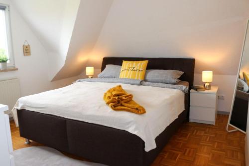 a bedroom with a large bed with white sheets at Ferienwohnung-Familie-Baasch in Embsen