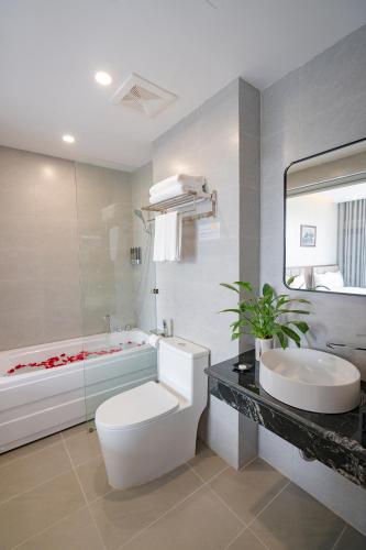 ein Badezimmer mit Toilette, Waschbecken und Badewanne in der Unterkunft Sun Hotel Sam Son in Sầm Sơn