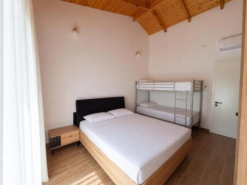 a bedroom with a bed and a bunk bed at Guesthouse Deshnica in Këlcyrë