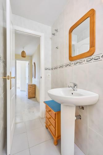 a white bathroom with a sink and a mirror at Blue View in Torrox Costa