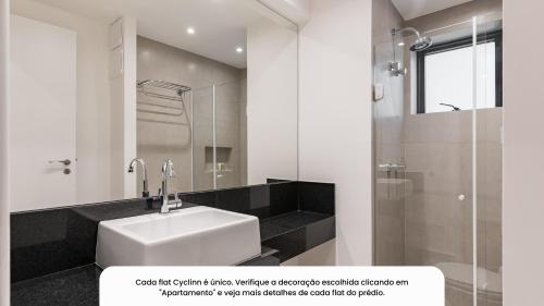 a white bathroom with a sink and a shower at Cyclinn Faria Lima Itaim in São Paulo