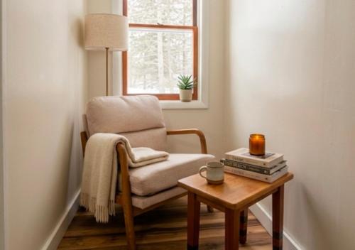 a living room with a chair and a table at Lakeside Heritage Resort in Carp Lake