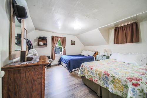 a bedroom with two beds and a television in it at The Wrens Nest in Baltic