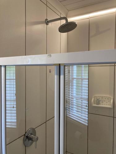 a bathroom with a shower with a glass door at Knysna Holiday Cottage in Knysna
