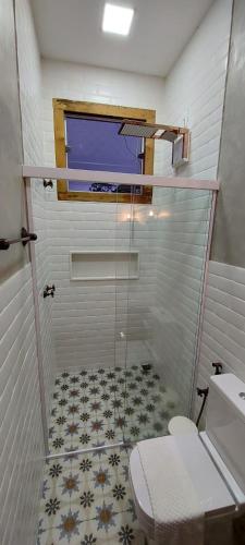 a bathroom with a shower with a toilet and a window at Hotel Vila Relicário in Ouro Preto