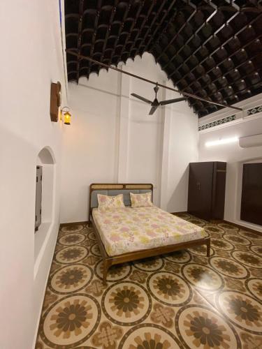 a bedroom with a bed and a rug at Umbrella Comfy Stays-Subbu in Madurai