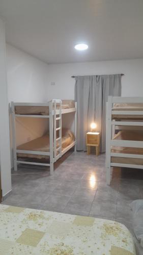 a room with three bunk beds in a room at Brisa de Pueblo in Caseros